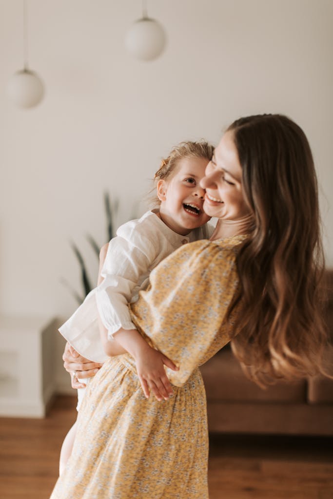 A happy mother and daughter sharing a joyful moment together in a cozy home setting.